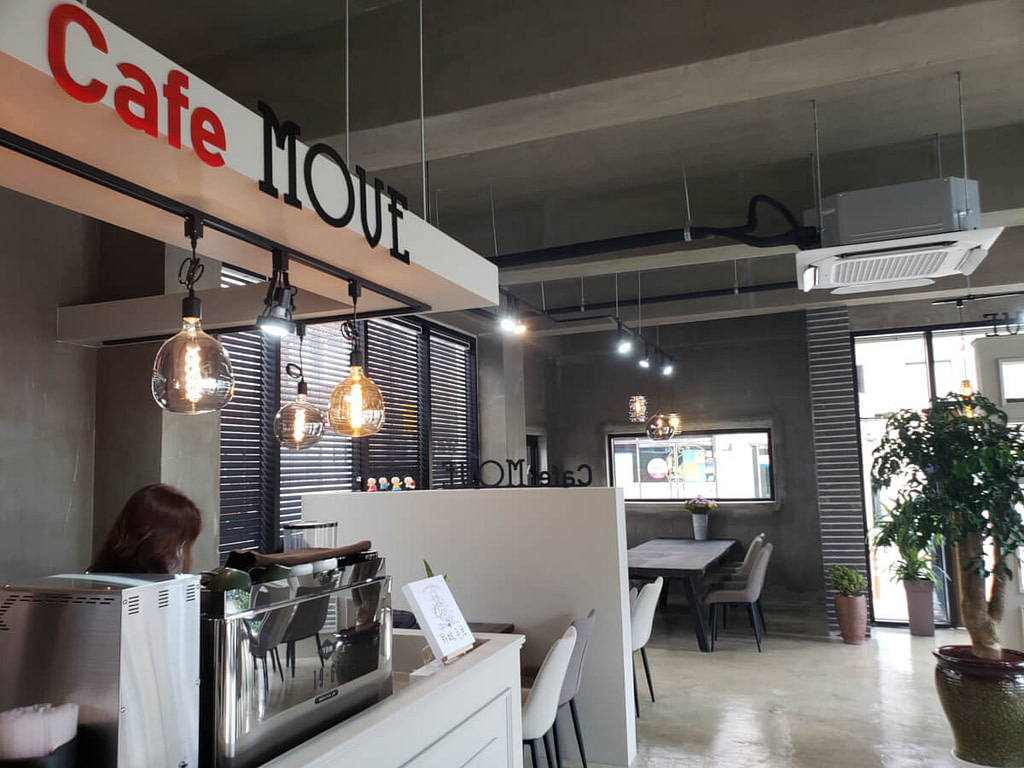 Café Move interior near ordering station next to large table