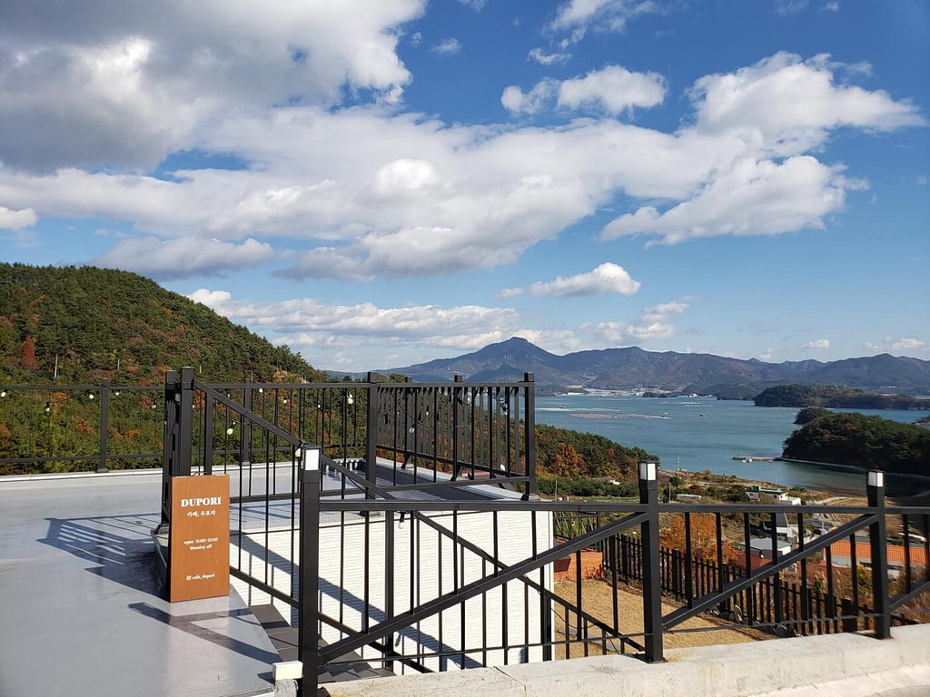 A sign and railing on the rooftop of Dupoli Café