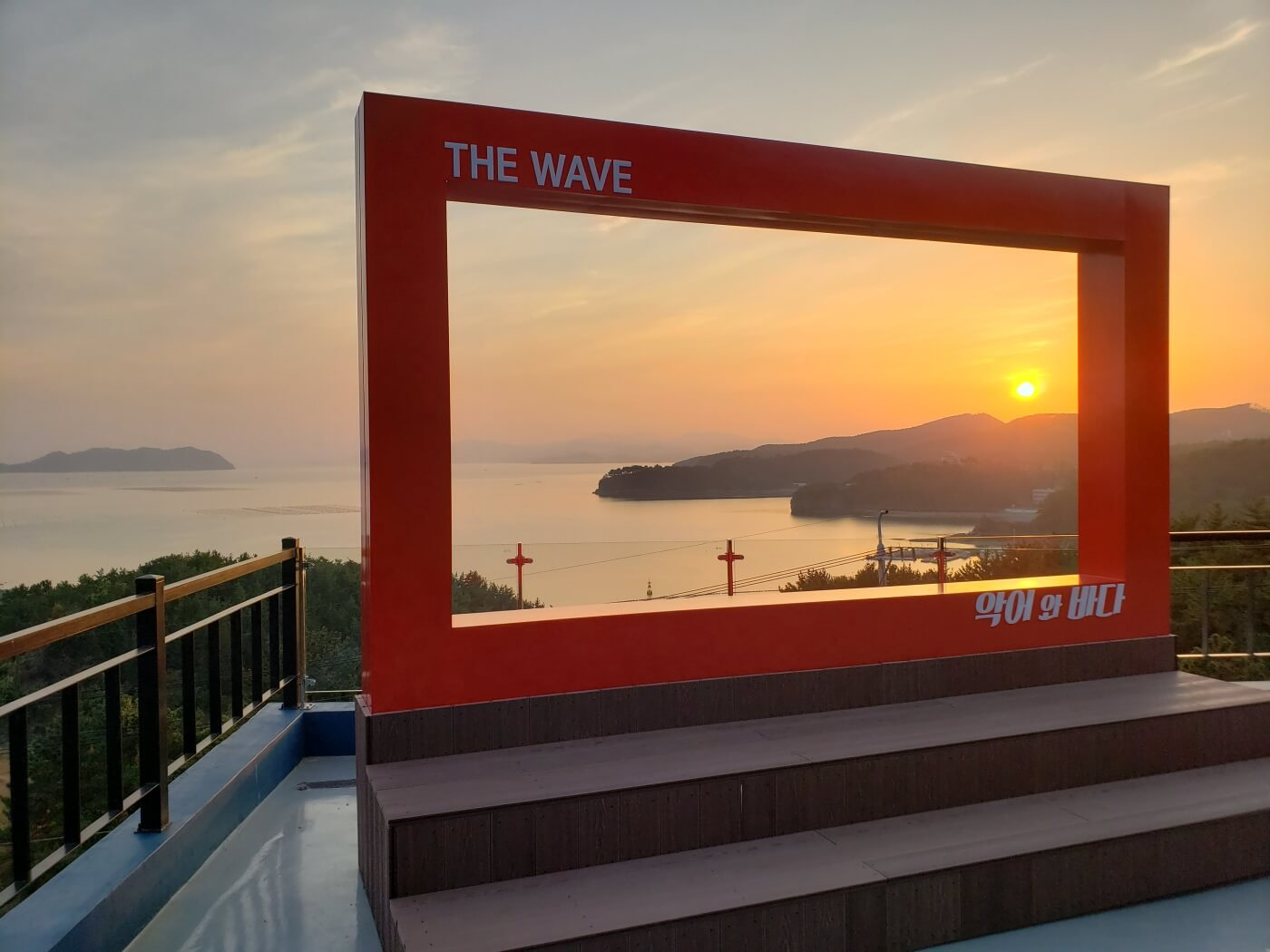 The sun setting within a red frame on a rooftop