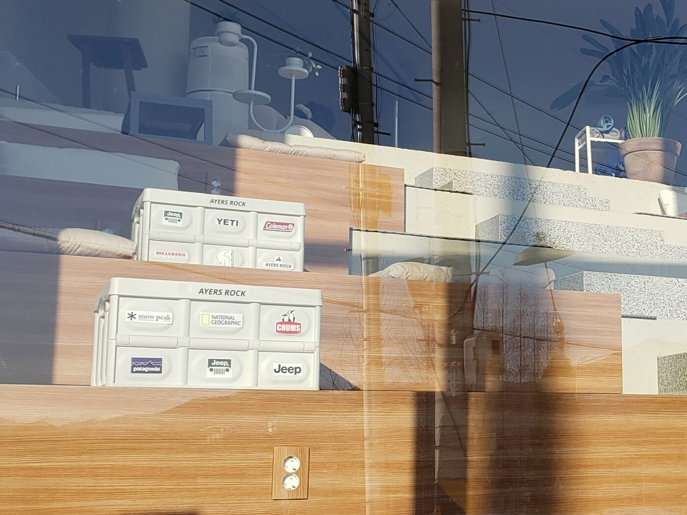 Crates covered in various logos on steps