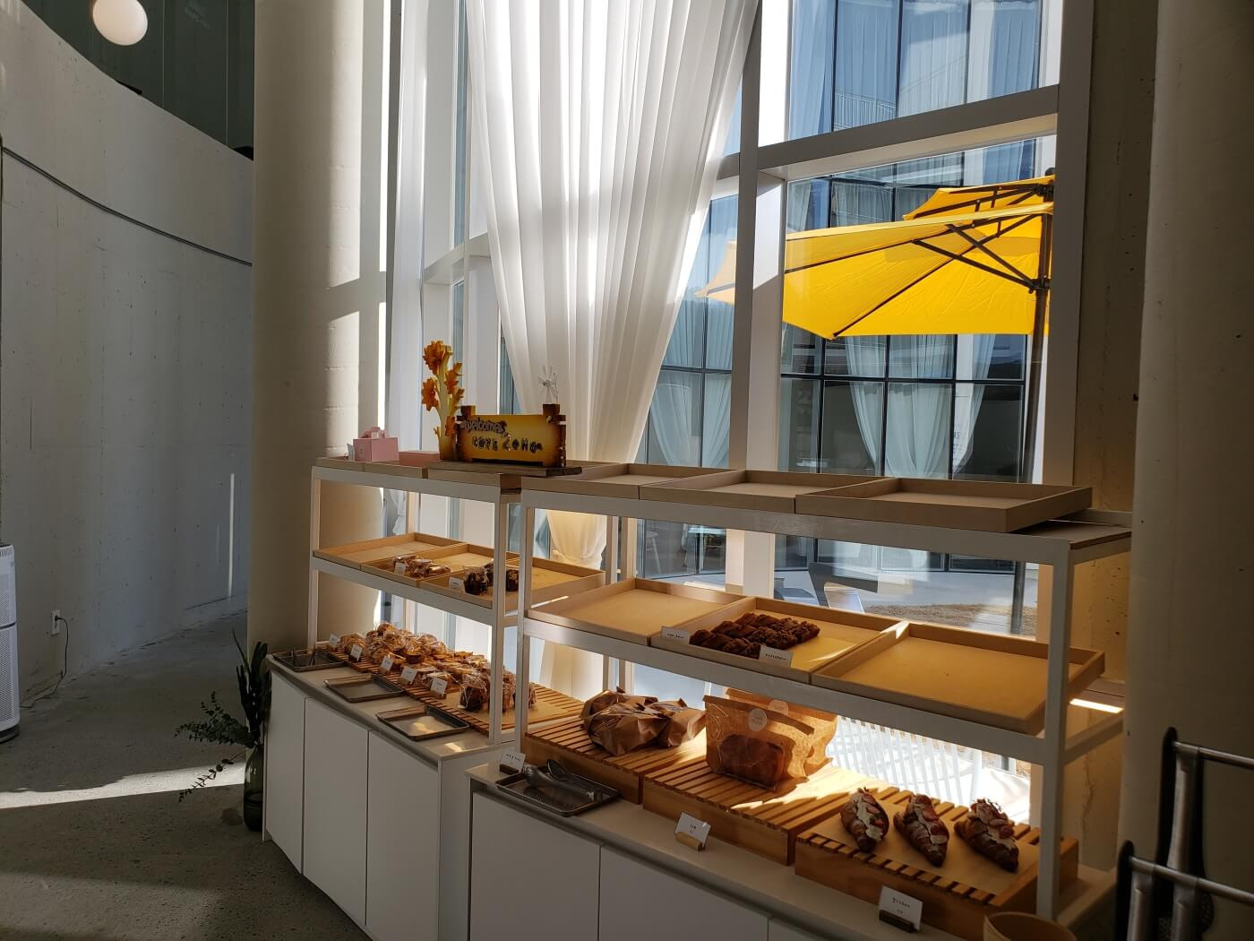 Pastries on display in front of a huge curtain and window at Cafe Zaha in Goseong, Korea