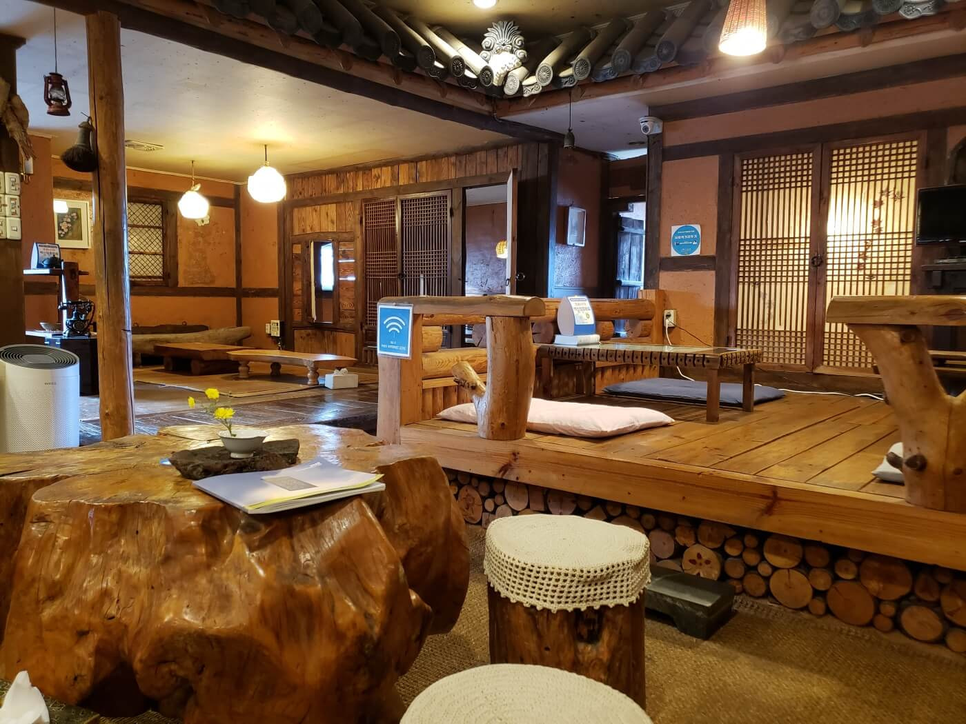 A wooden stump tables and stools in a hanok teahouse