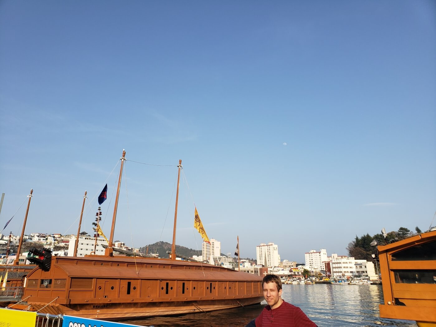 Nate standing next to turtle ships docked