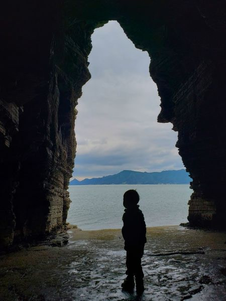 Baby Noah standing under a cave opening at Sangjogam Park