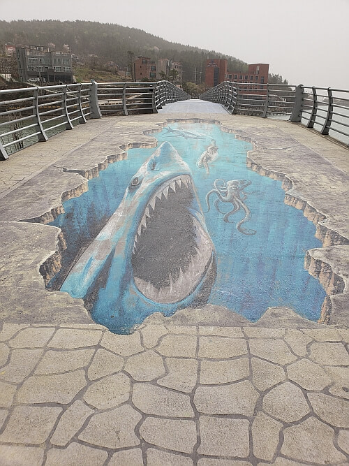 A shark painted on Haejigae Bridge crossing over the water