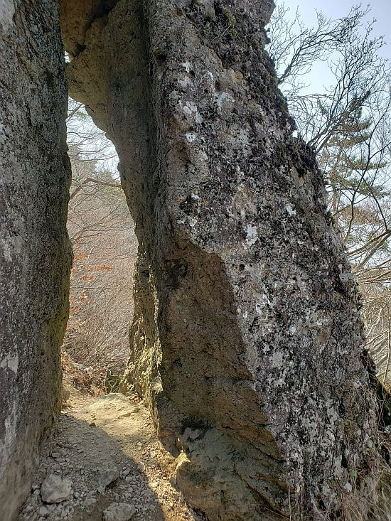 A cave-like rock with a large hole in the middle