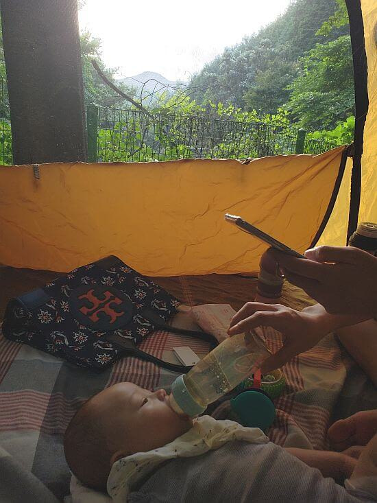 Noah bottle feeding in the tent