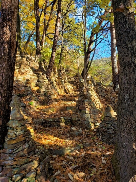 Stacks of rocks along a path through Yeonhwasan Provincial Park in the fall