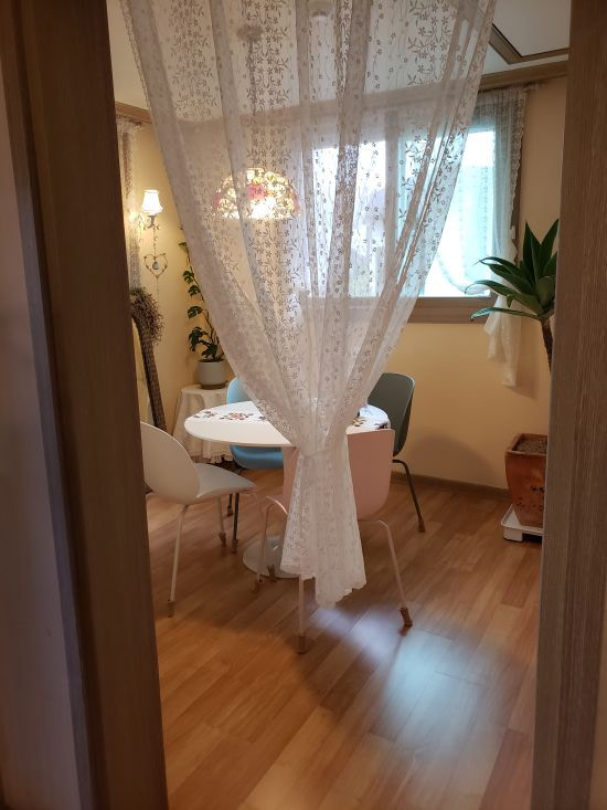 A white curtain draped over the entrance to a small private room in a café