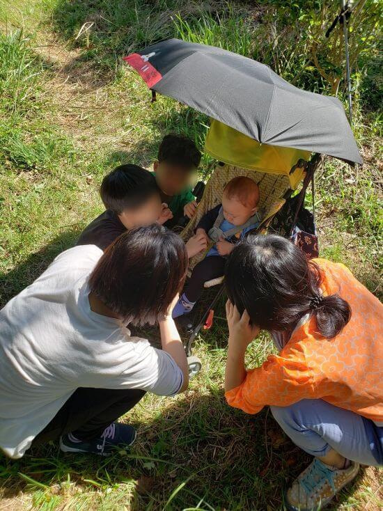 People gathered around baby Noah in a stroller