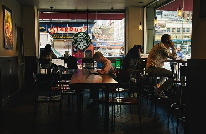 People sitting and working individually at an American café