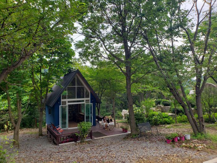 A couple enjoying the deck of a small building in the forest