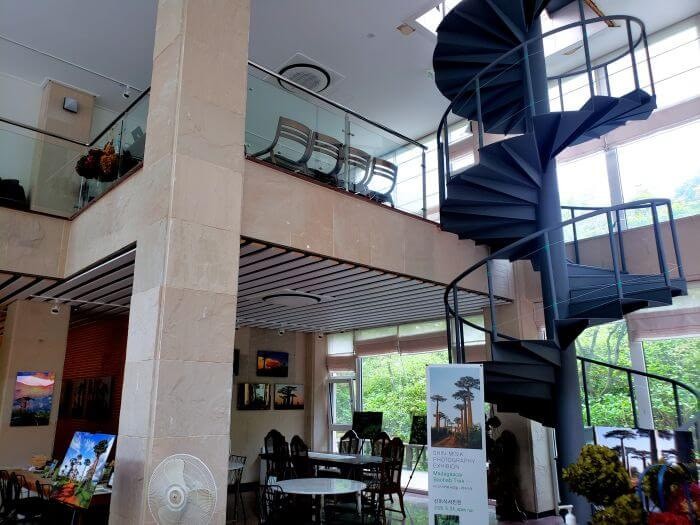A spiral staircase inside a building with a photo gallery