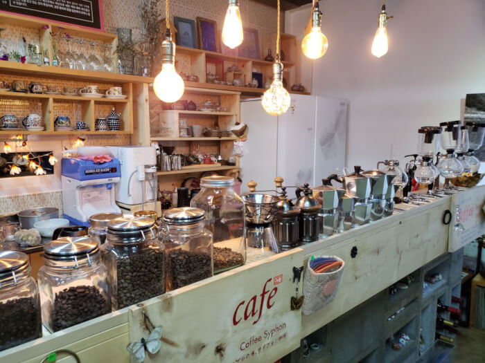 Row of coffee jars and various items on a shelf