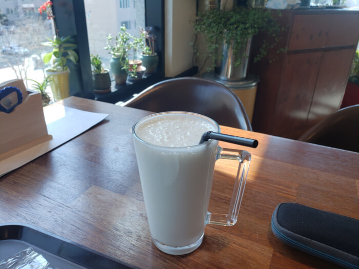 Glass of ginseng milky tea on a table