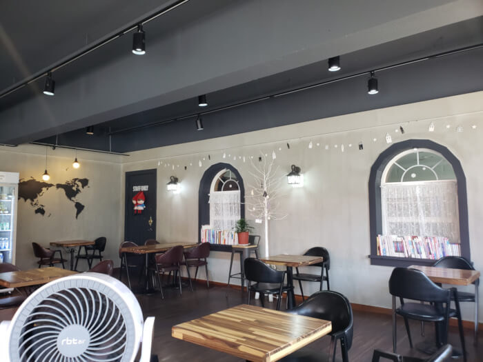 Interior of café with tables and a fan