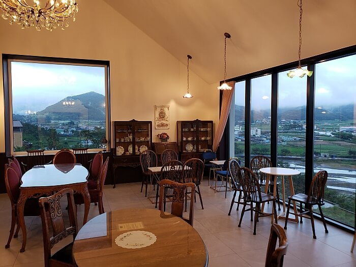 Second floor of Fortuna Café with large windows and tables
