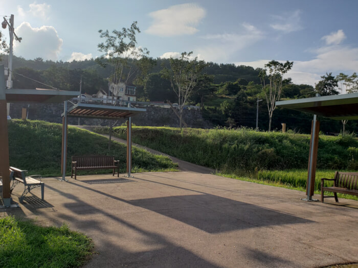 An open patio area with benches along the bike path