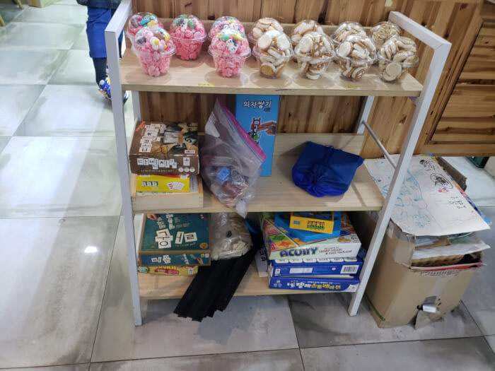 Bowls of cookies and various board games on some shelves