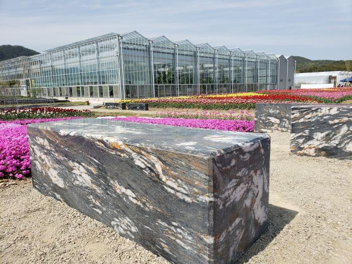 Marble stone benches near the greenhouses