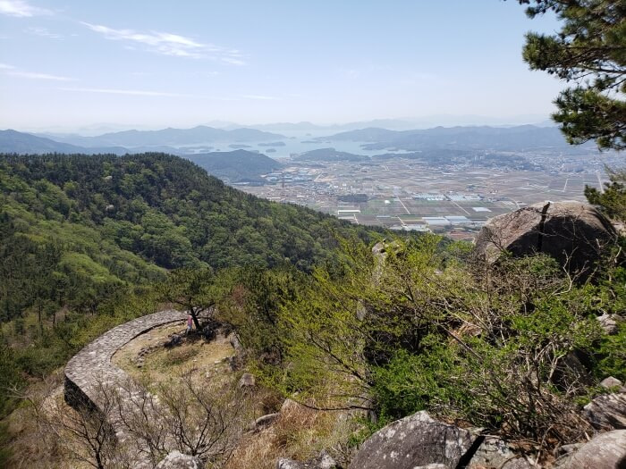 The Goseong Fortress Wall from above against a backdrop of the mountains and towns of Goseong