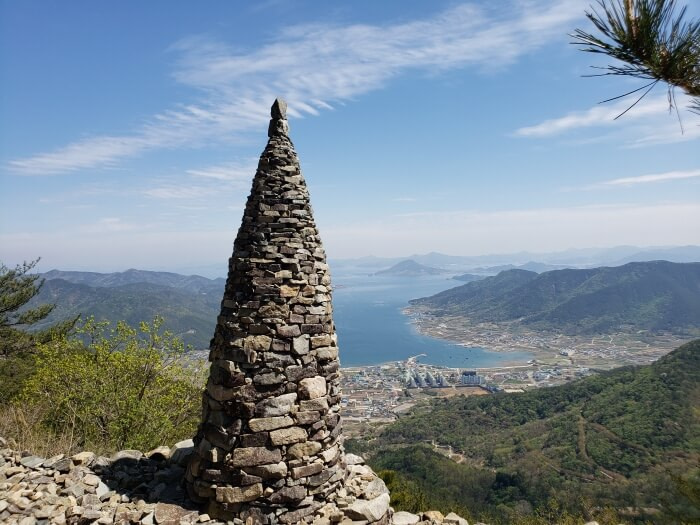 Pagoda of stacked stones overlooking the sea and towns of Goseong