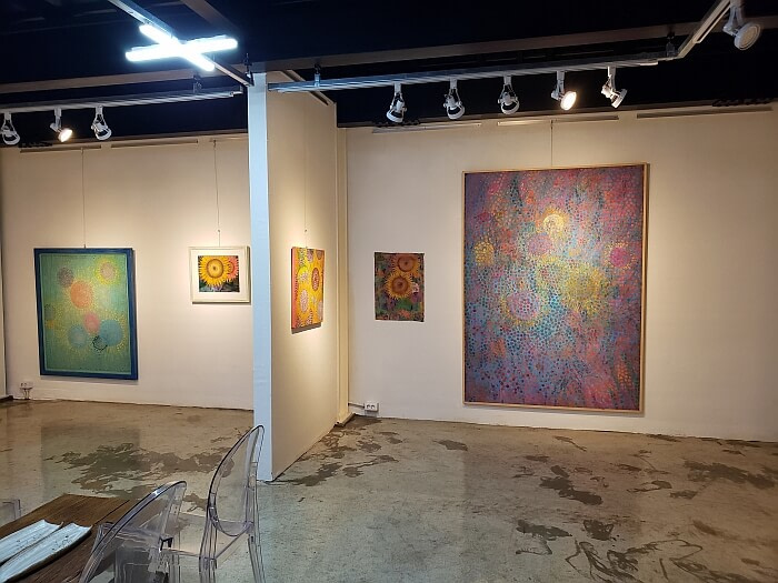 Paintings of various sizes on the walls of the Geulibom art gallery and studio