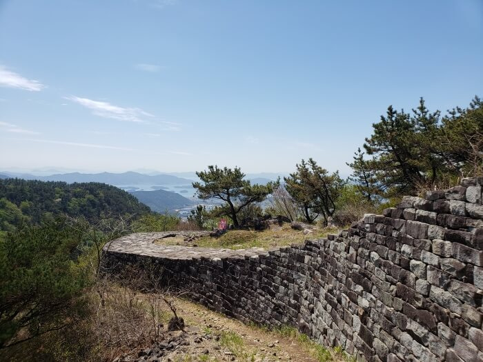 The Goseong Fortress Wall wrapping around terrain below the peak of Georyusan
