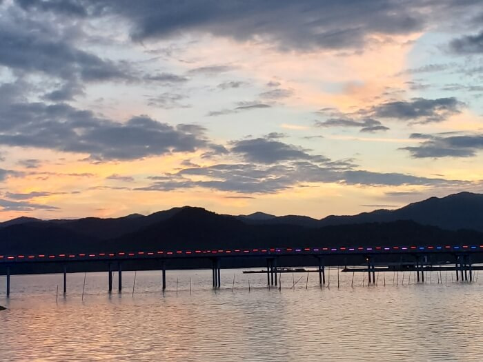 View of Haejigae Bridge from Sunset Café during a sunset over the mountains and water