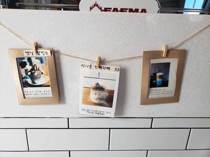 Pictures of some menu items clipped onto a string along the counter