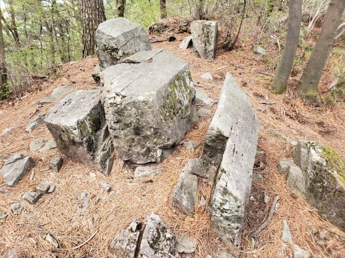 Rocks jutting out from the ground that look as if they were cut down the middle