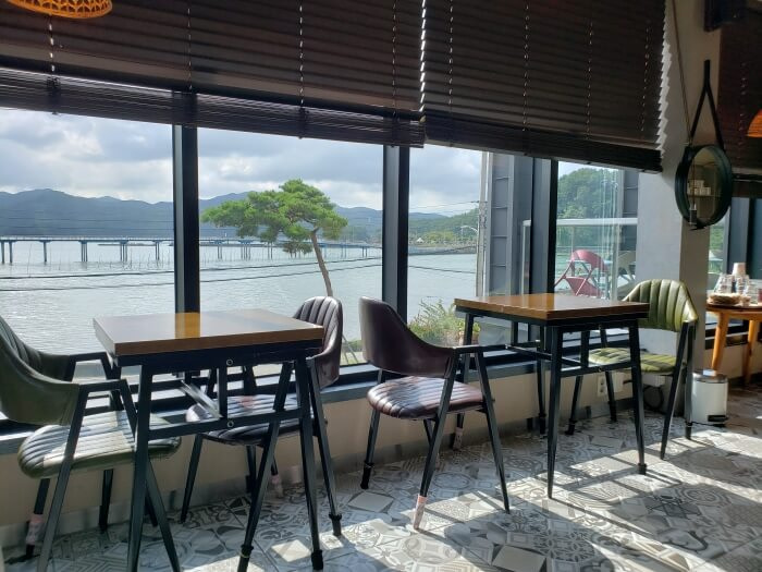 Sunlight shining through the windows and falling on tables and casting shadows on the floor