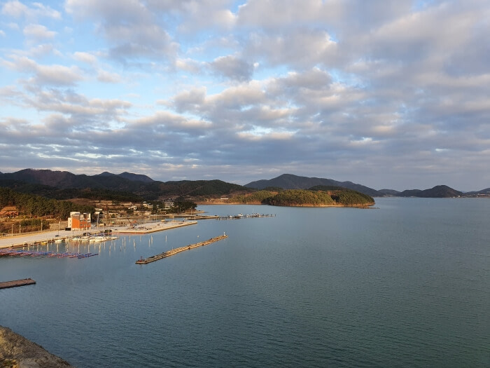 View from the top of the cliff overlooking the sea and spotty clouds close to sunset