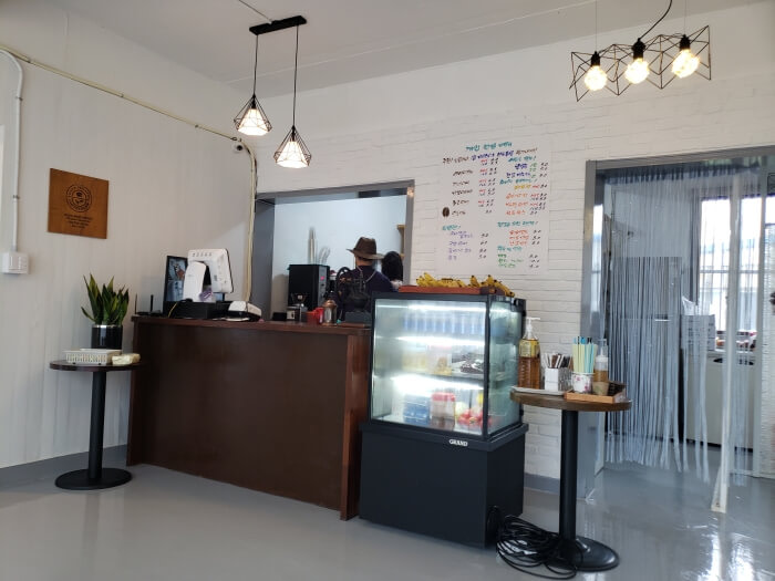 Dalgotjeongwon ordering station and counter with hanging lights overhead