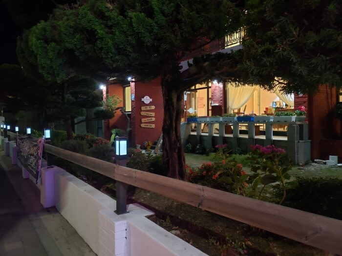 A fence with light posts along the front of Dalgotjeongwon Café at night
