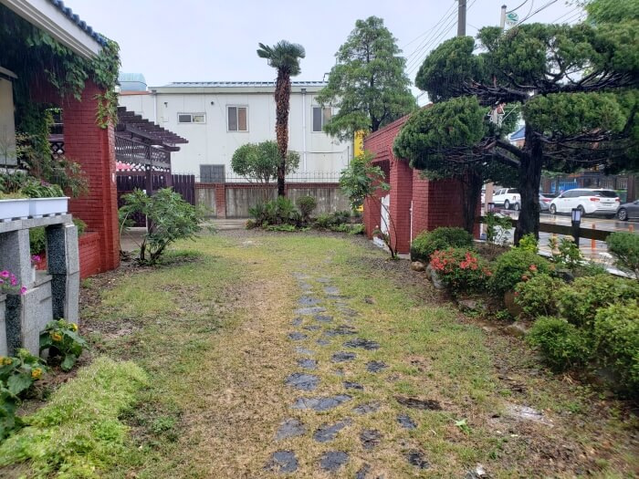 A stone pathway in the grass leading to the front entrance of Dalgotjeongwon Café