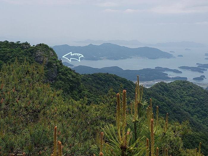 Maebawi Rock in the distance against a background of islands in the water