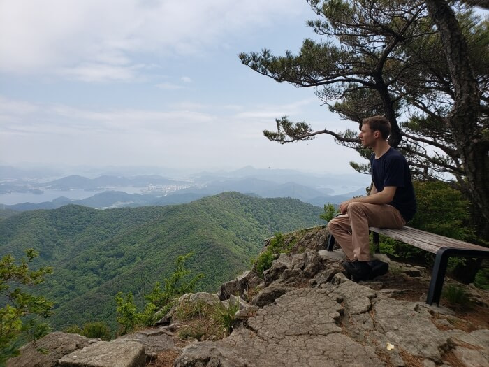 Nate sitting on a bench looking out at the nice view at Byeogbangsan