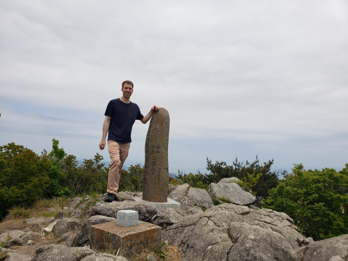 Nate standing next to the Byeogbangsan headstone
