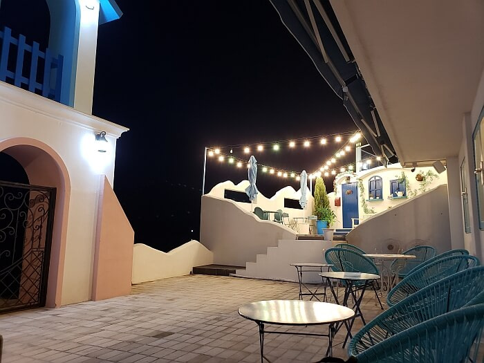 Tables and chairs set up on an outside patio at night