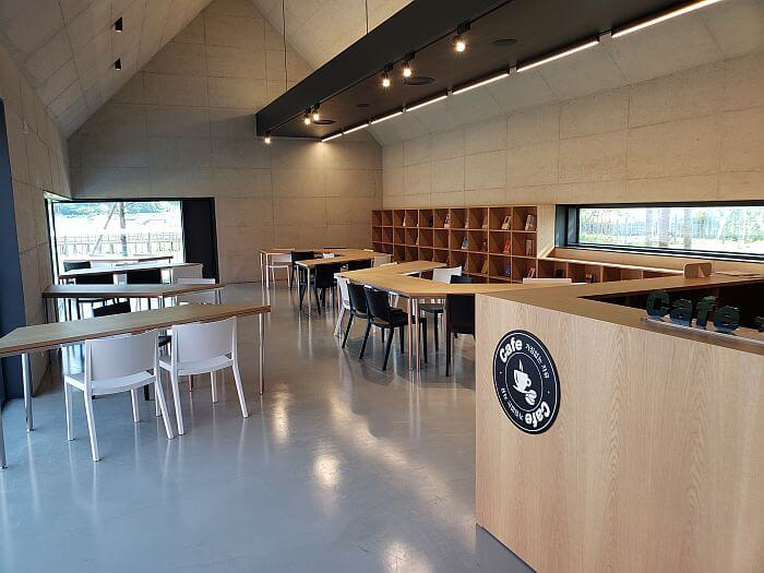 Interior of the book café at Daega Reservoir with cubbies of books and a pointed ceiling