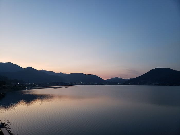 Daega Reservoir at sunset with a reflection cast upon the calm water