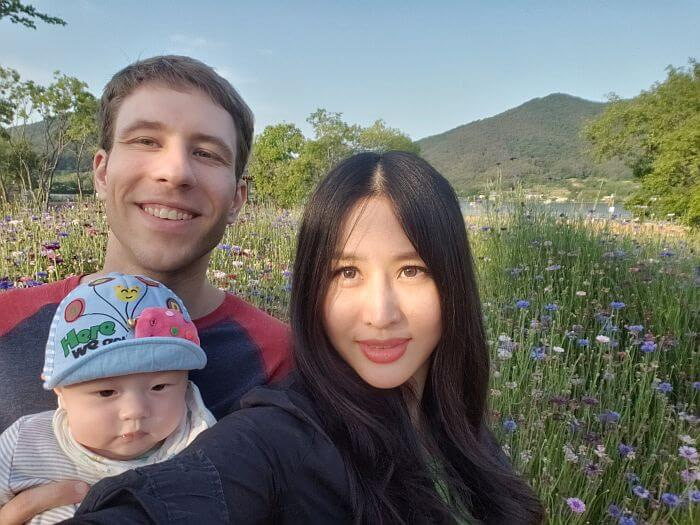 Nate, Alice, and Noah in front of wildflowers
