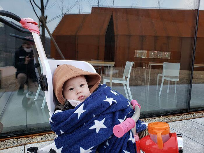 Baby Noah wrapped in a blanket in a stroller