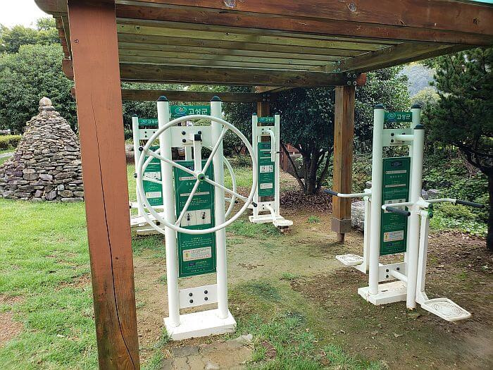 Exercise equipment under a covering in the grass