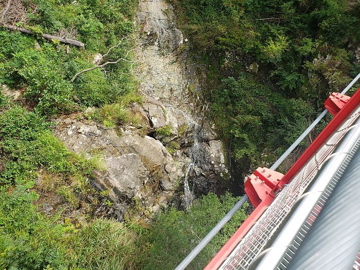 Looking down into the crevice over which the suspension bridge crosses