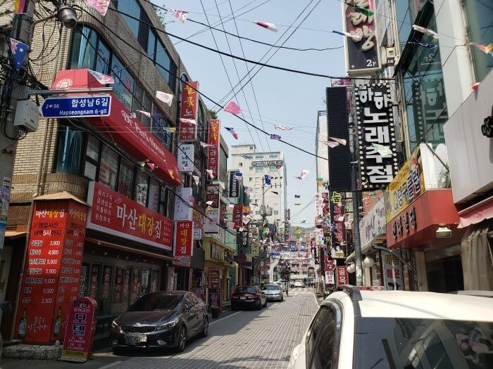 A Korean street with many businesses and signs
