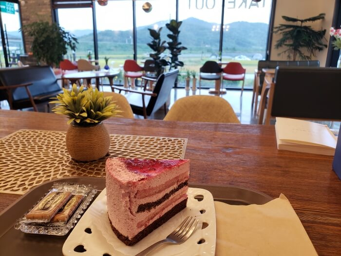 A piece of strawberry cake on a table in a café