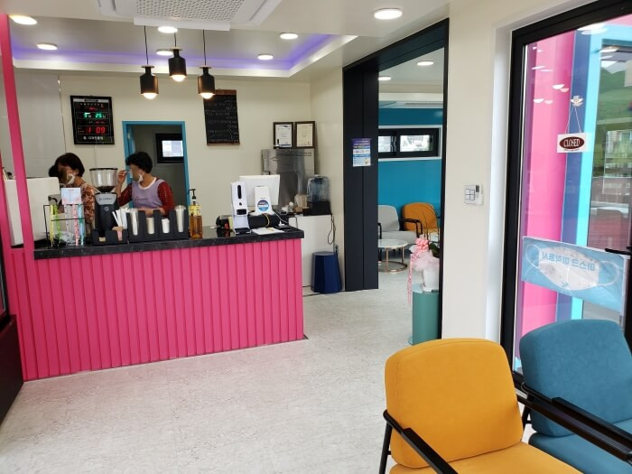 A pink counter and the interior of a café