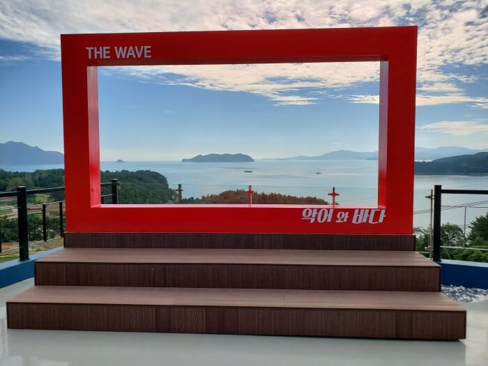 A red frame on a rooftop with a view of islands in the sea